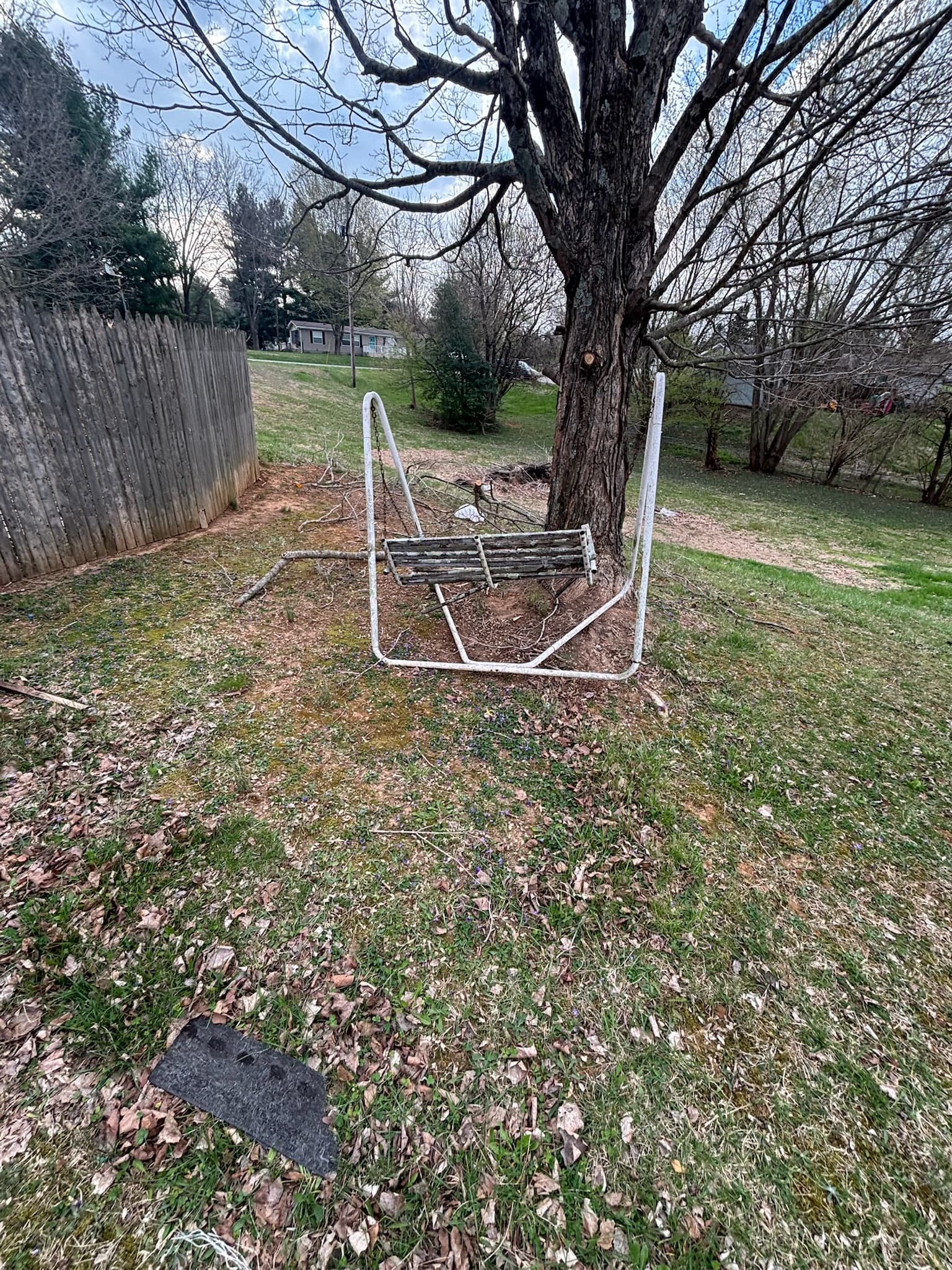 Before: yard swing and debris awaiting removal